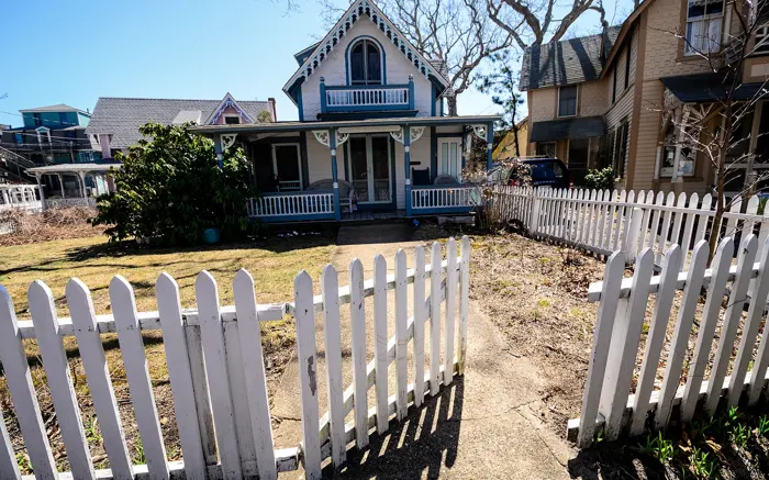 White picket fence in front of a house
